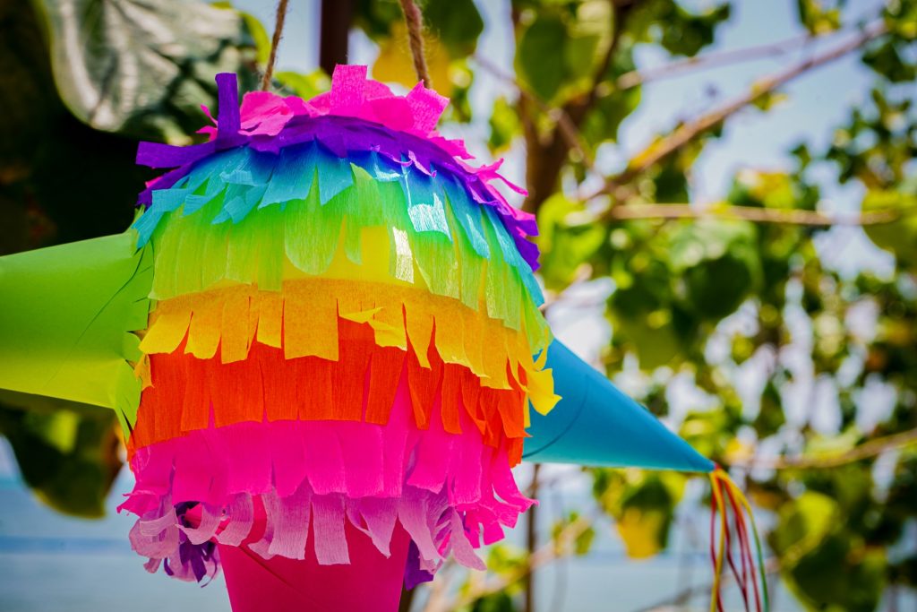 Various shades of hanging paper decorations create a cheerful and inviting ambiance.