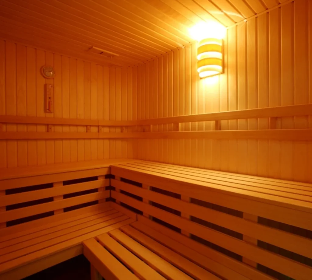 A photo captures the sauna sparkling warmly in soft, golden glowing light.